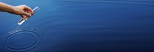 Banner Water Sample. Hand Collects Water To Explore. Concept Water Purity Analysis, Environment, Ecology. Water Testing For Infections, Permission To Swim. Selective Focus, Place For Text